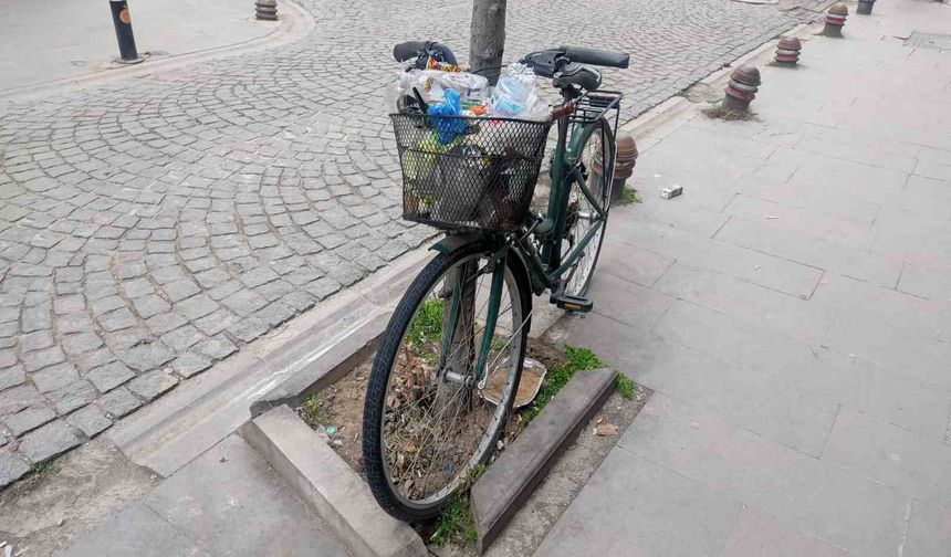 Aylardır ağaca kilitli duran bisikleti çöp kutusuna çevirdiler